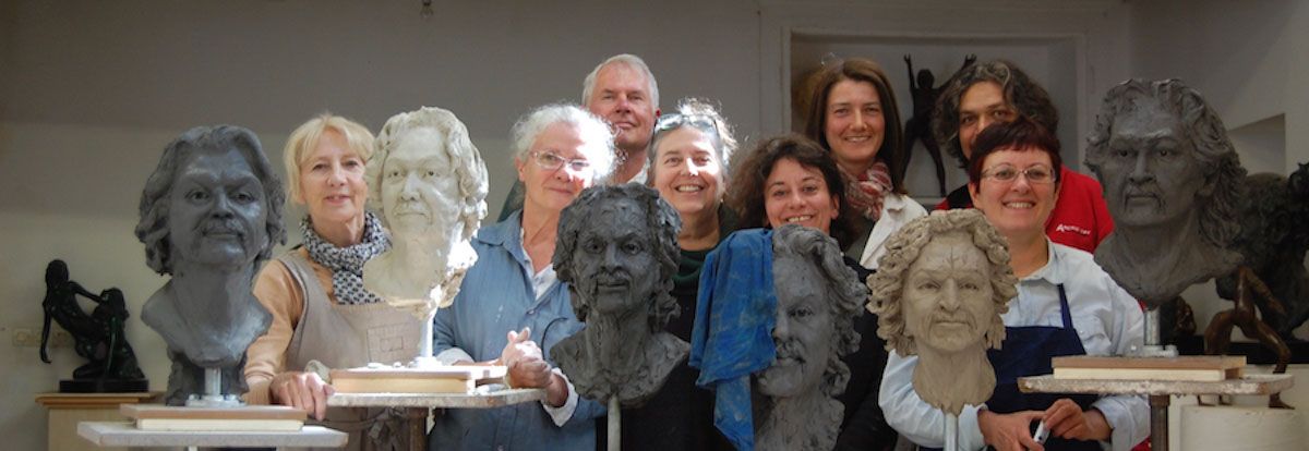 Portrait Sculpture Class - students posing with their busts